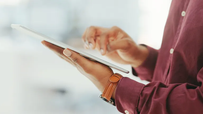 Person holding a tablet.